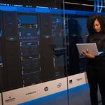 software engineer standing beside server racks